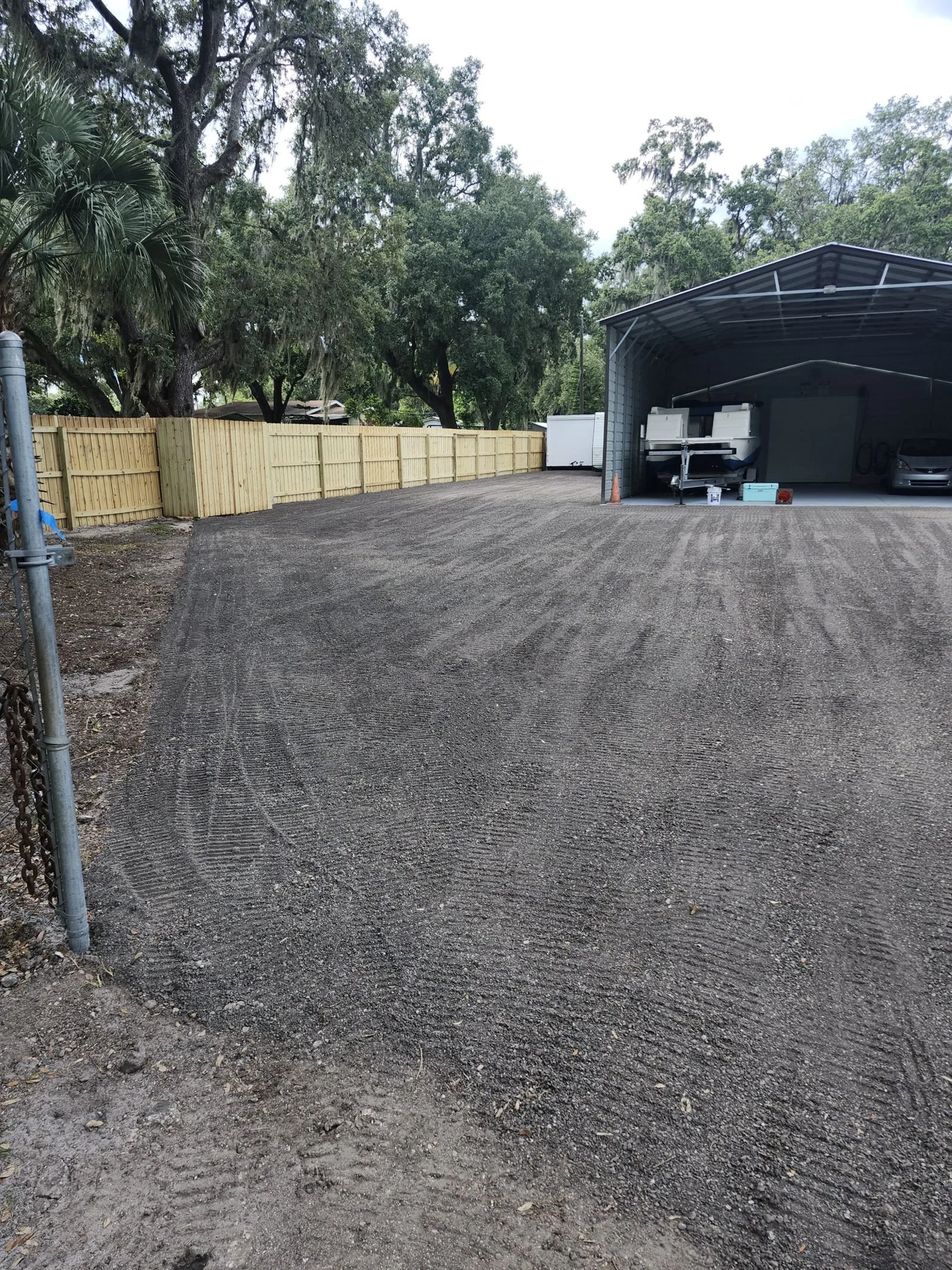 The Polk Services truck and equipment trailer staged for a grading job.