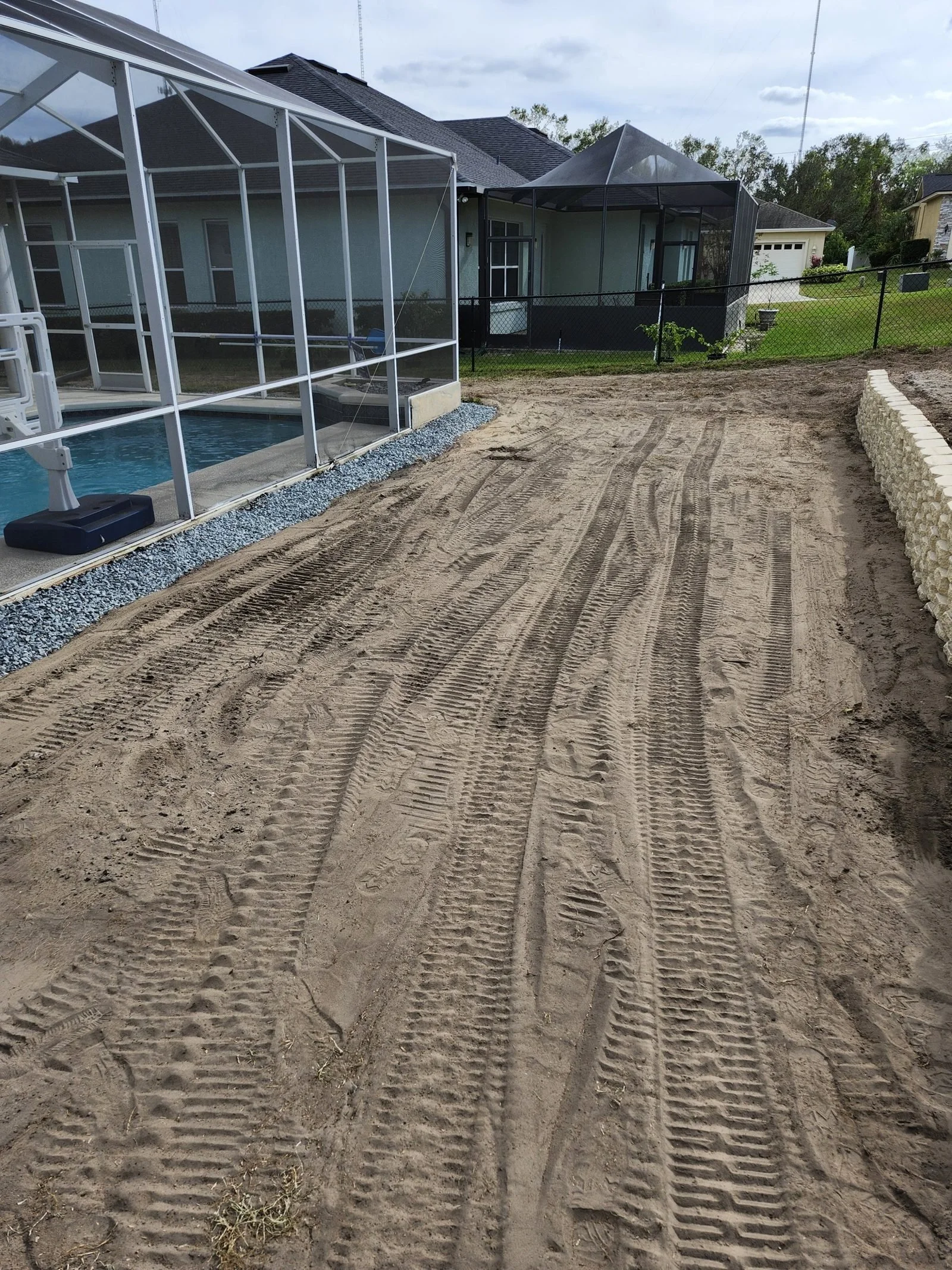 Polk Services grading and ground leveling in Lakeland, FL — a yard leveled with heavy machinery.