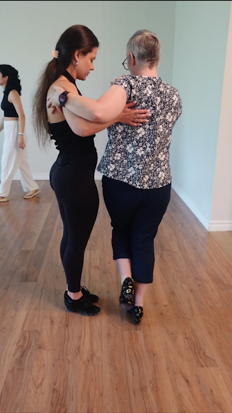 Dance Lounge instructor dancing with an adult student