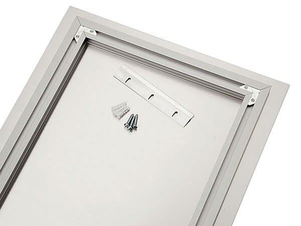 Rear view of an acrylic print with inset frame, French cleat, screws, and wall anchors
