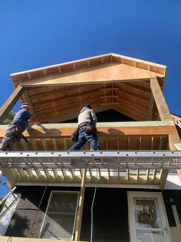 Crew framing a roof addition