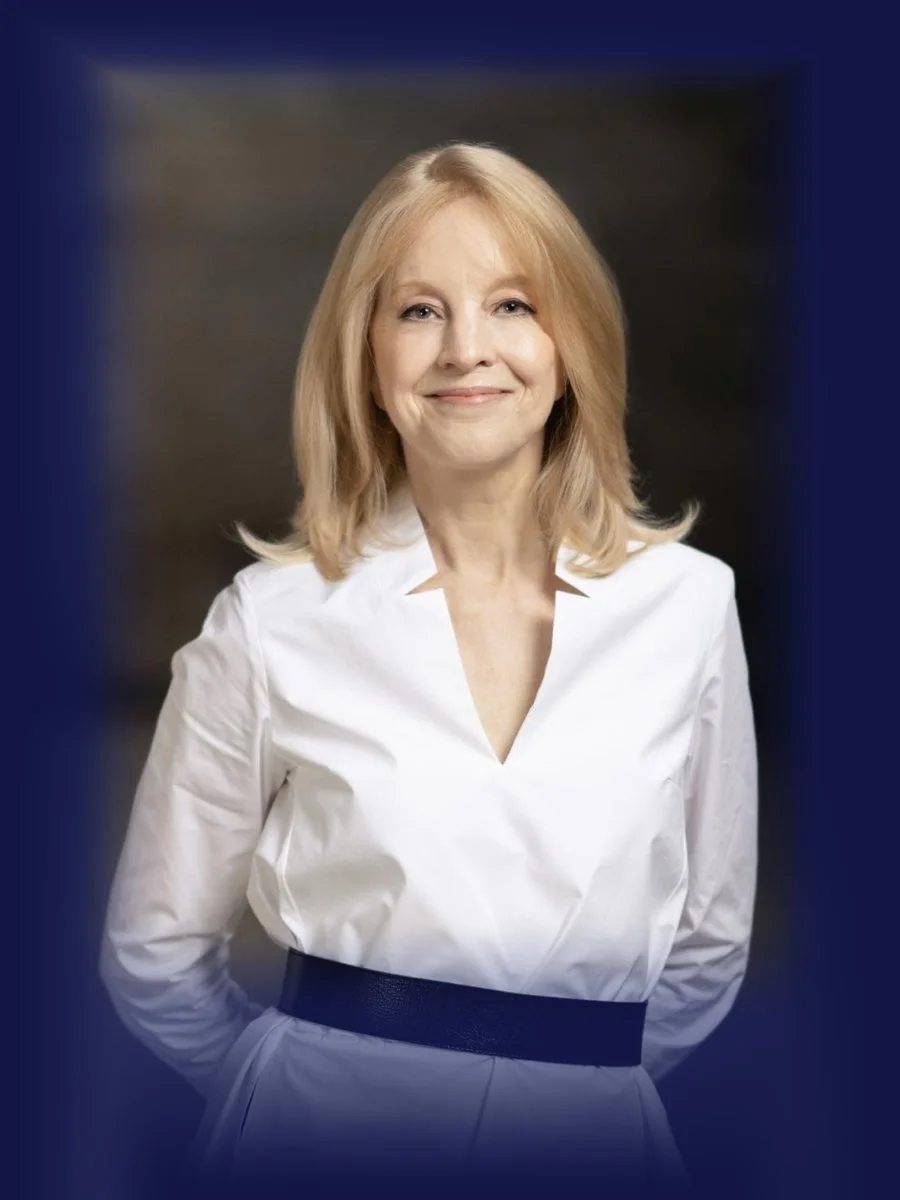 Maria Schneider in a white shirt, smiling