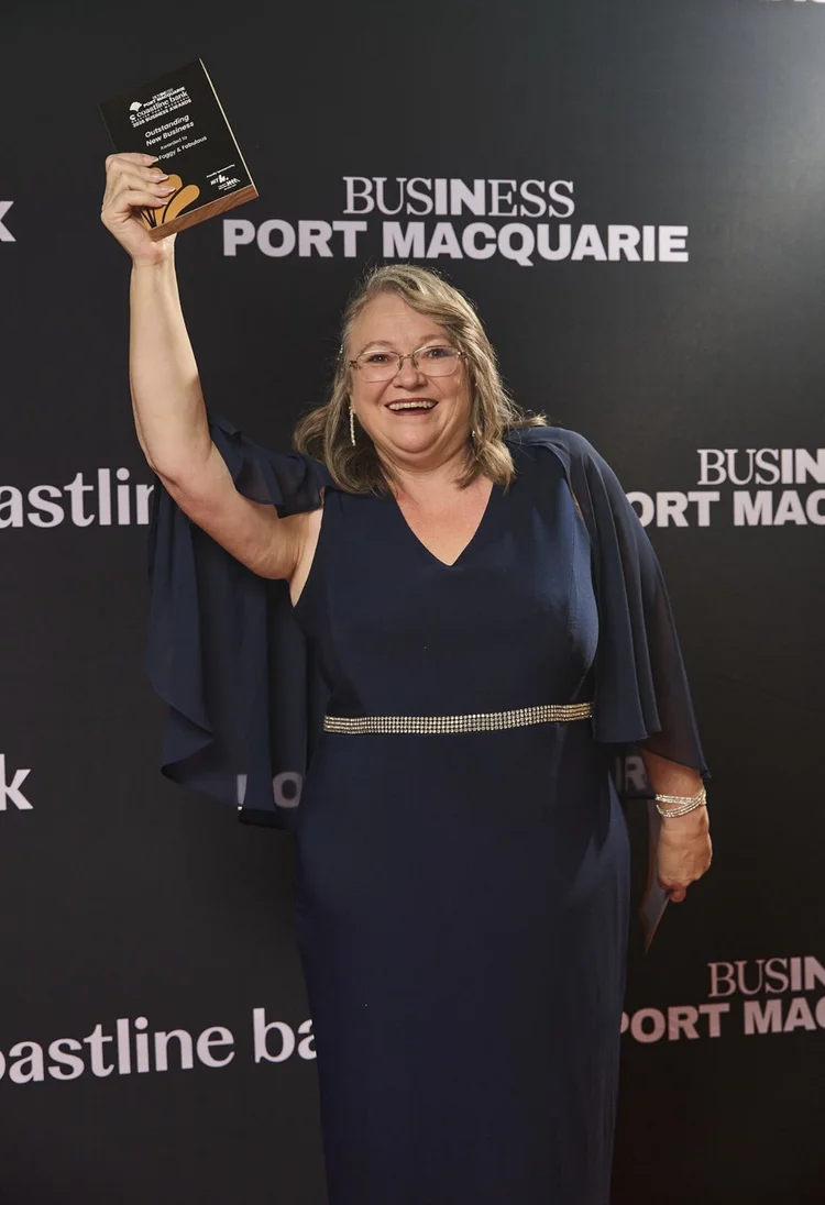 Susan holding her Outstanding New Business award