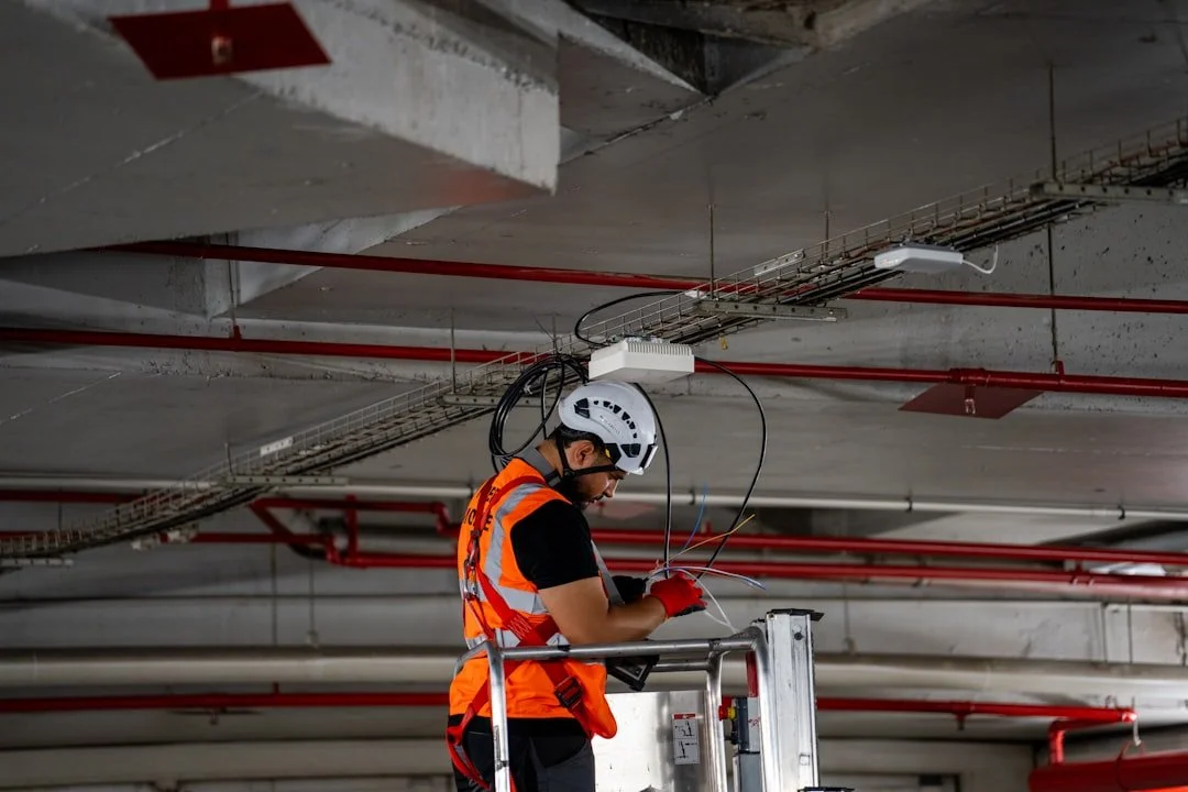 Aerial lift operator properly harnessed and tied off at elevation