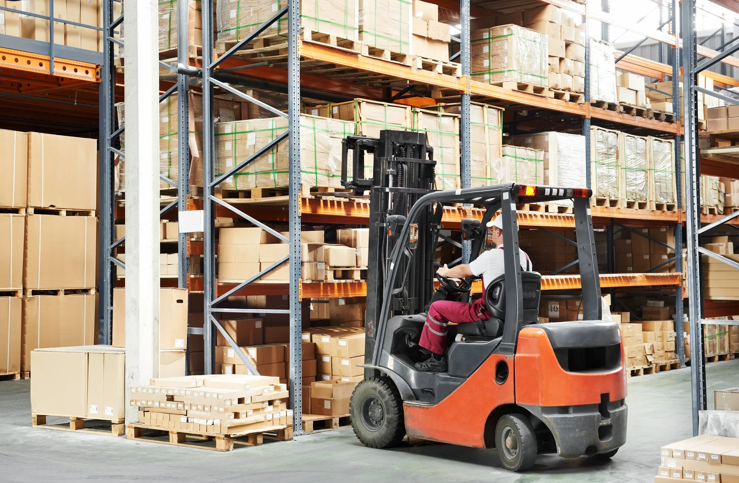 Forklift driver operating Powered Industrial Truck in industrial setting