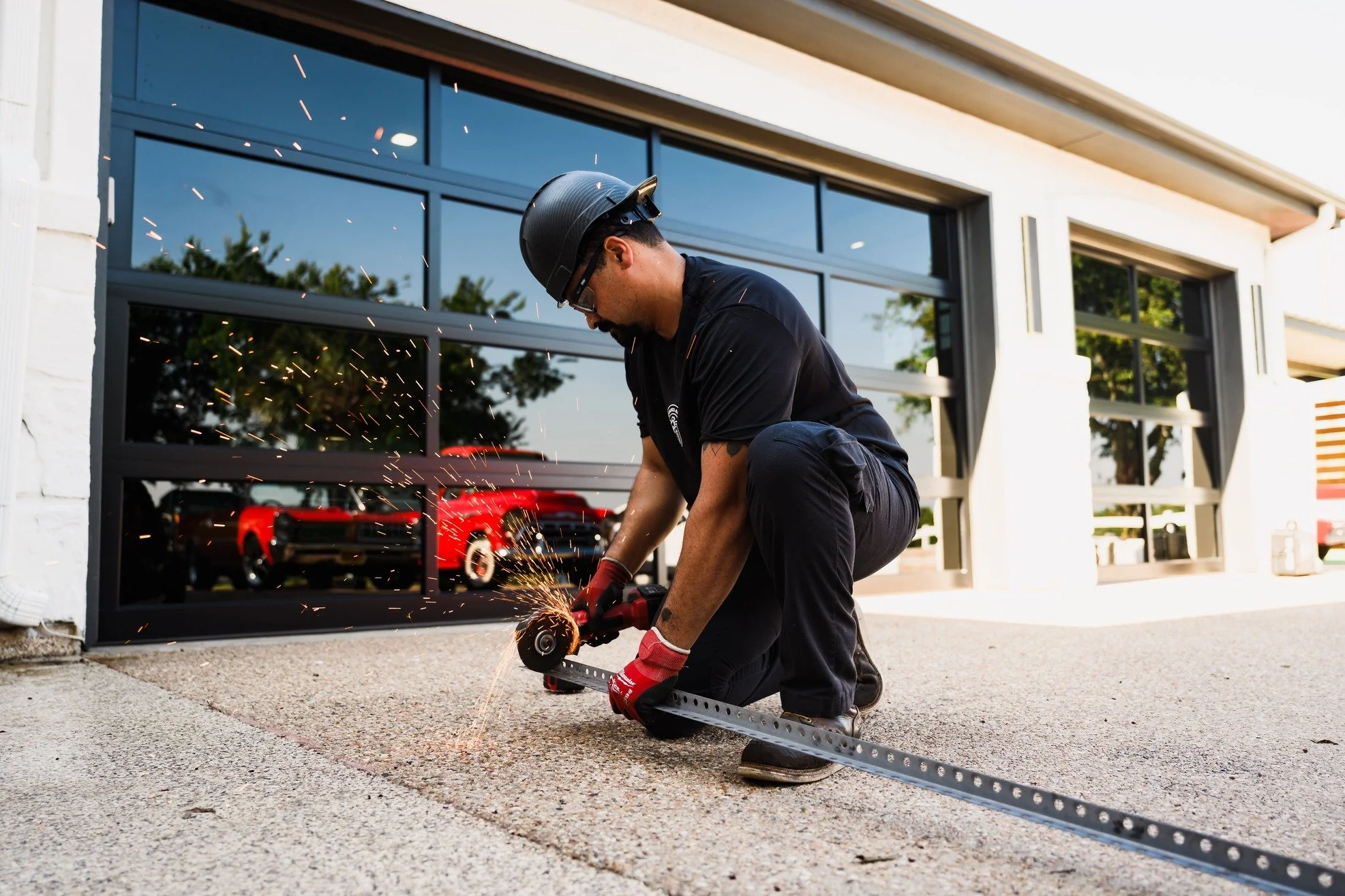 a technician re-anchoring a garage door track into the jamb framing on an established Brushy Creek home in Brushy Creek, TX by Squared Away Garage Door Service