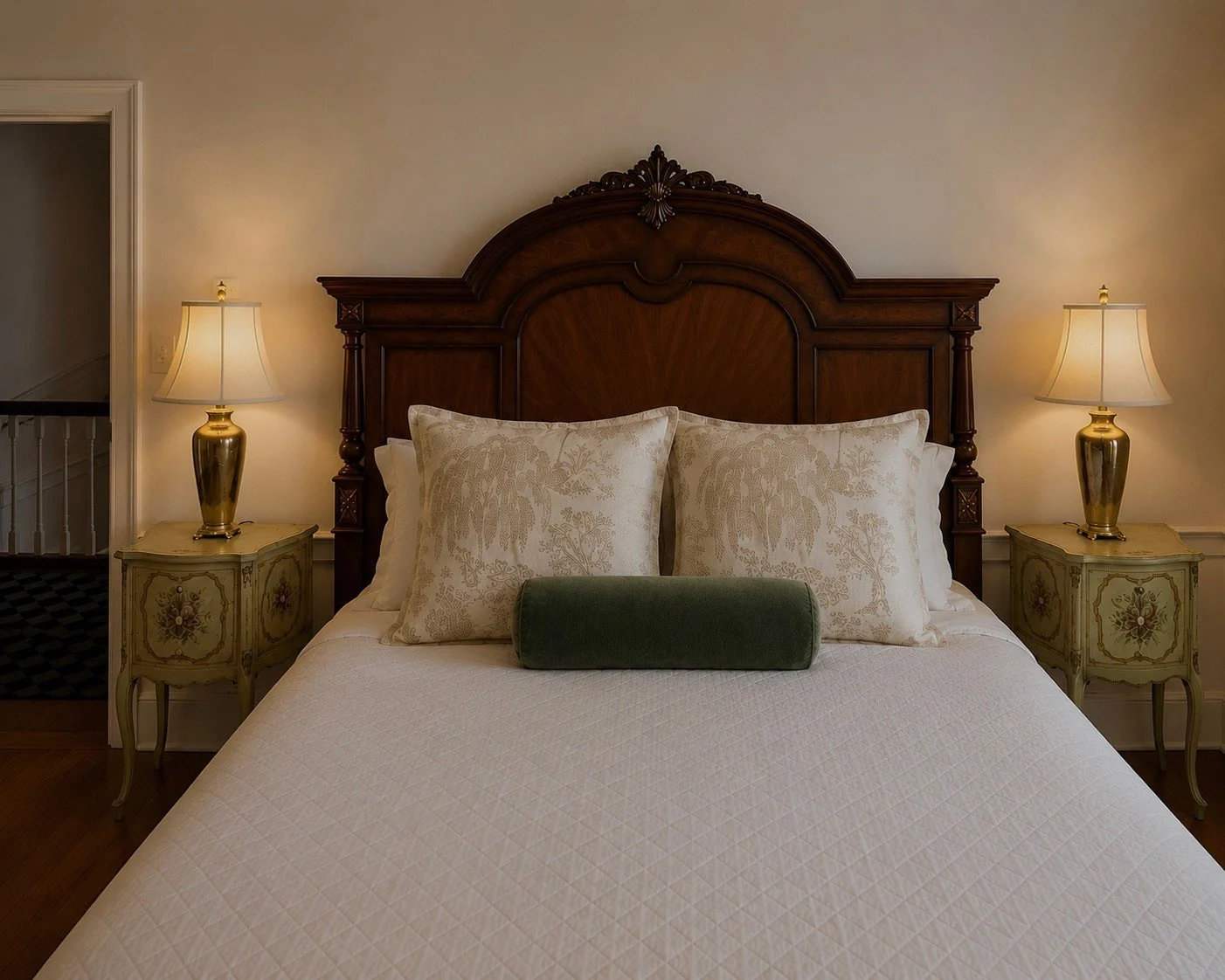 A refreshed Buxton Inn guest room with a carved dark-wood bed