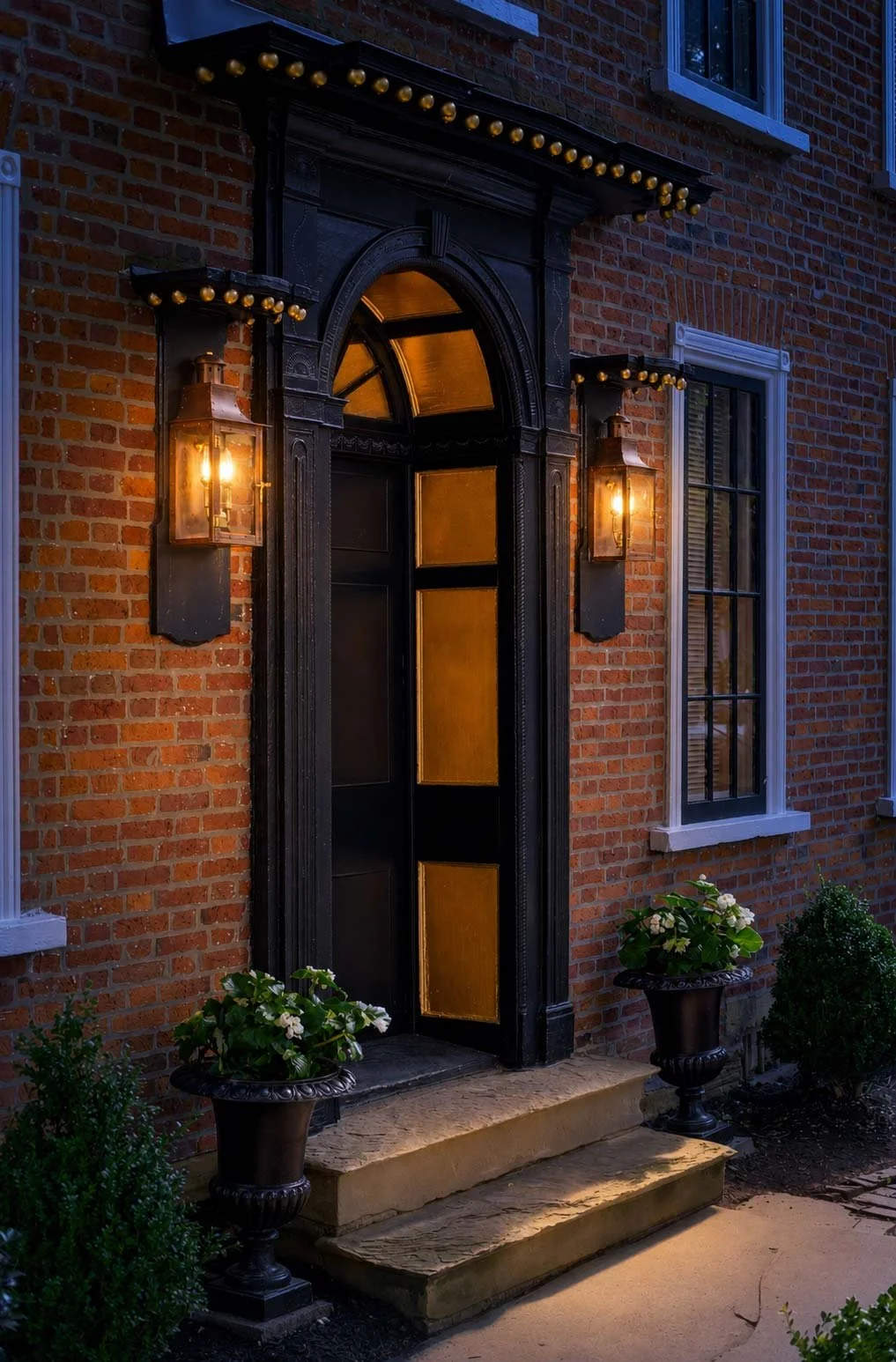 Illuminated historic entrance at Warner House.