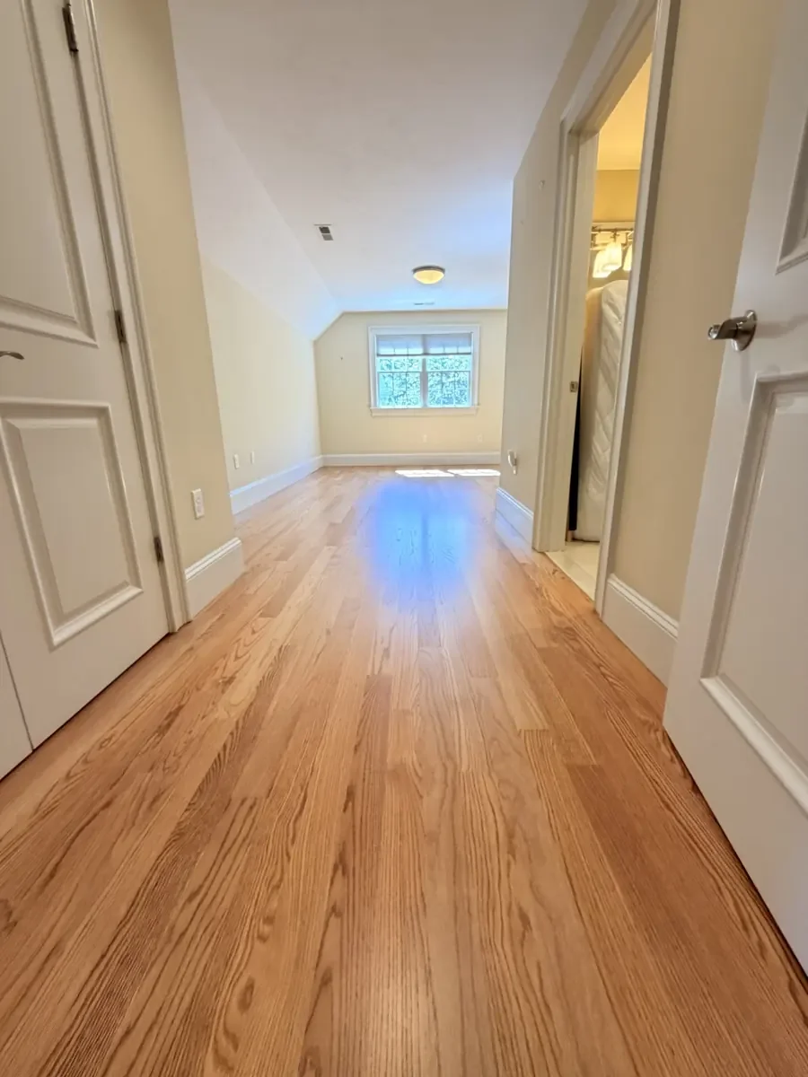Completed red oak flooring in the Wellesley hallway and rear bedroom