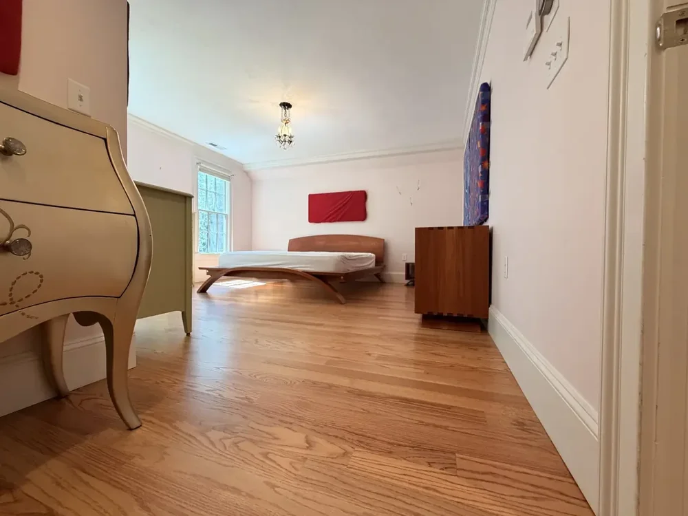 Furnished Wellesley bedroom with completed red oak flooring