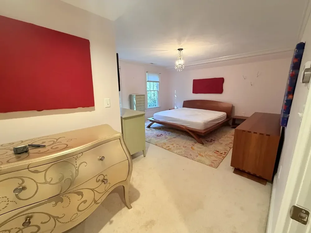 Furnished bedroom before the Wellesley flooring project