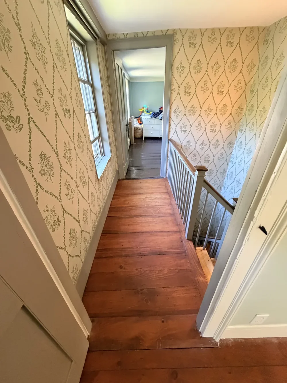 Wallpapered landing toward bedroom before refinishing