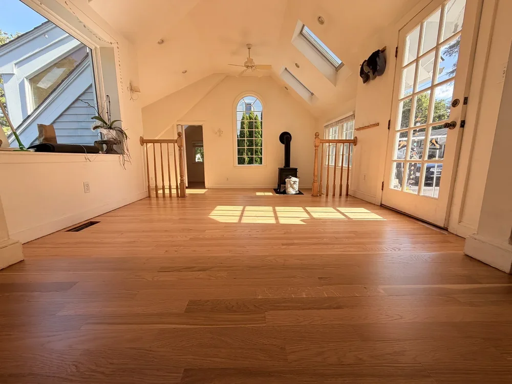 Refinished hardwood extending into the bright vaulted sunroom