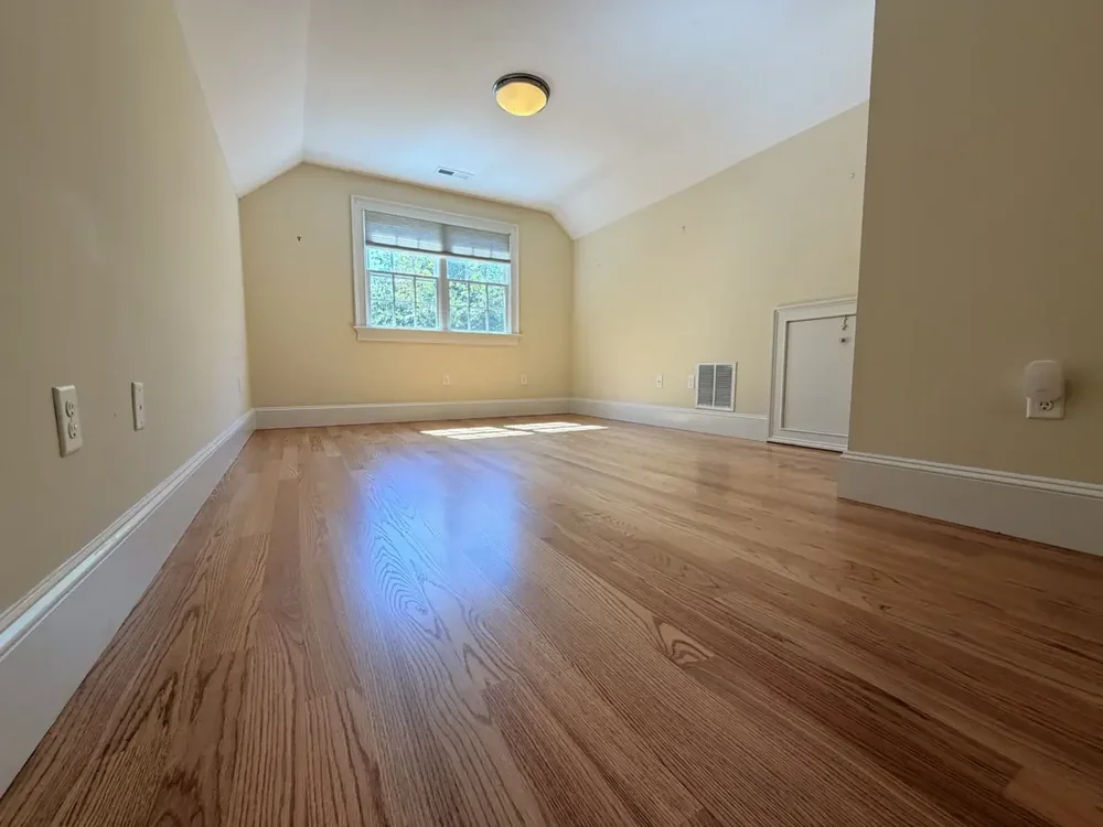 Completed red oak flooring in the Wellesley hallway and rear bedroom