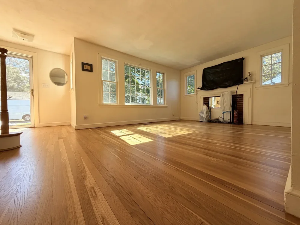 Living room after hardwood floor sanding and refinishing in Concord