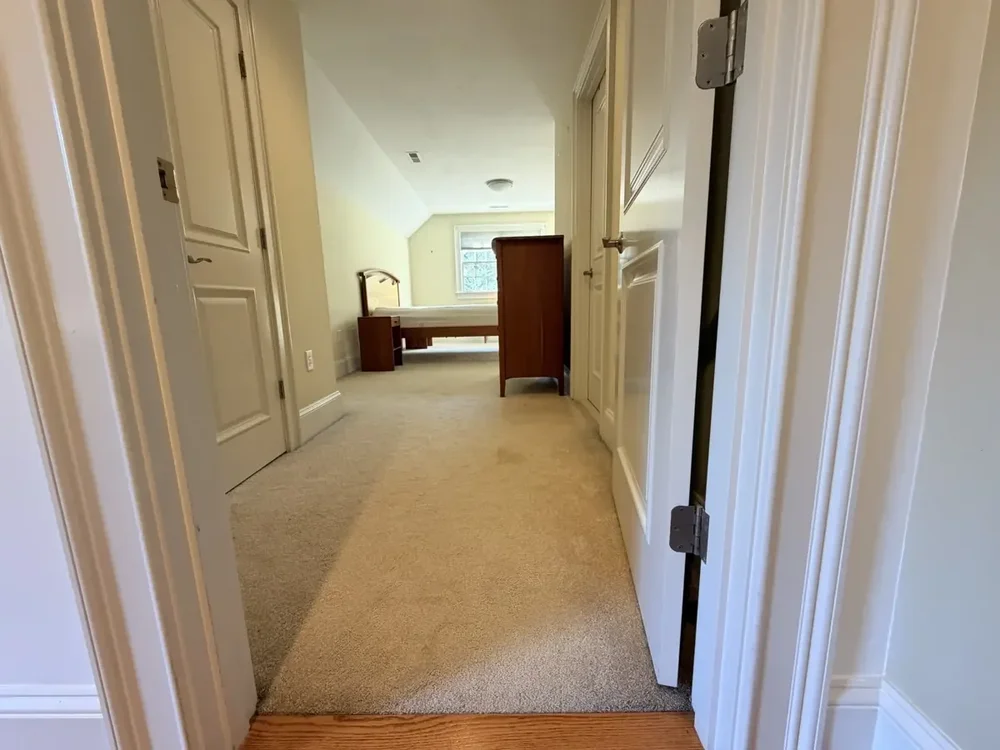 Hallway with furniture returned before the Wellesley flooring project