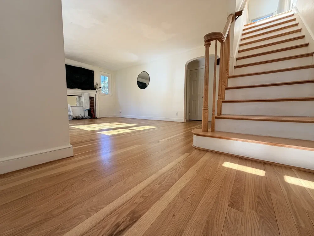 Refinished hardwood around the main staircase