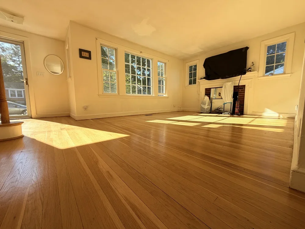 Living room before hardwood floor sanding and refinishing in Concord