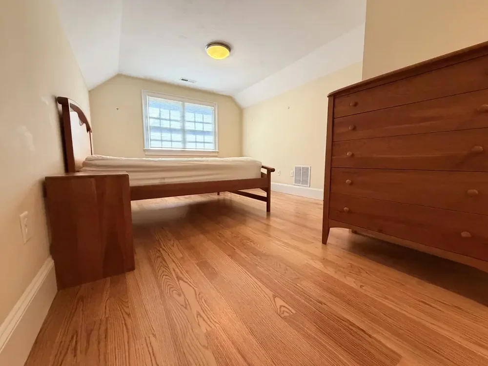 Rear bedroom with furniture returned after red oak installation and finishing