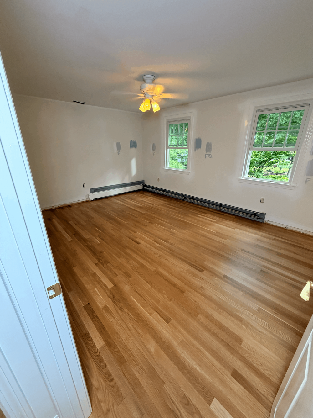 Site-finished white oak flooring beneath the windows