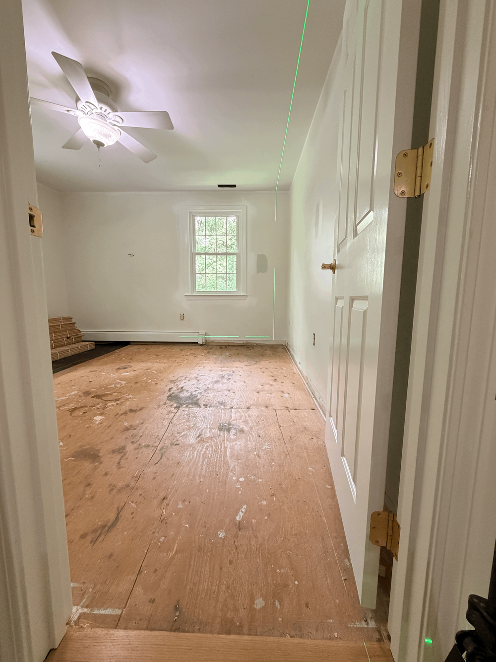 Exposed Andover subfloor with green laser layout reference