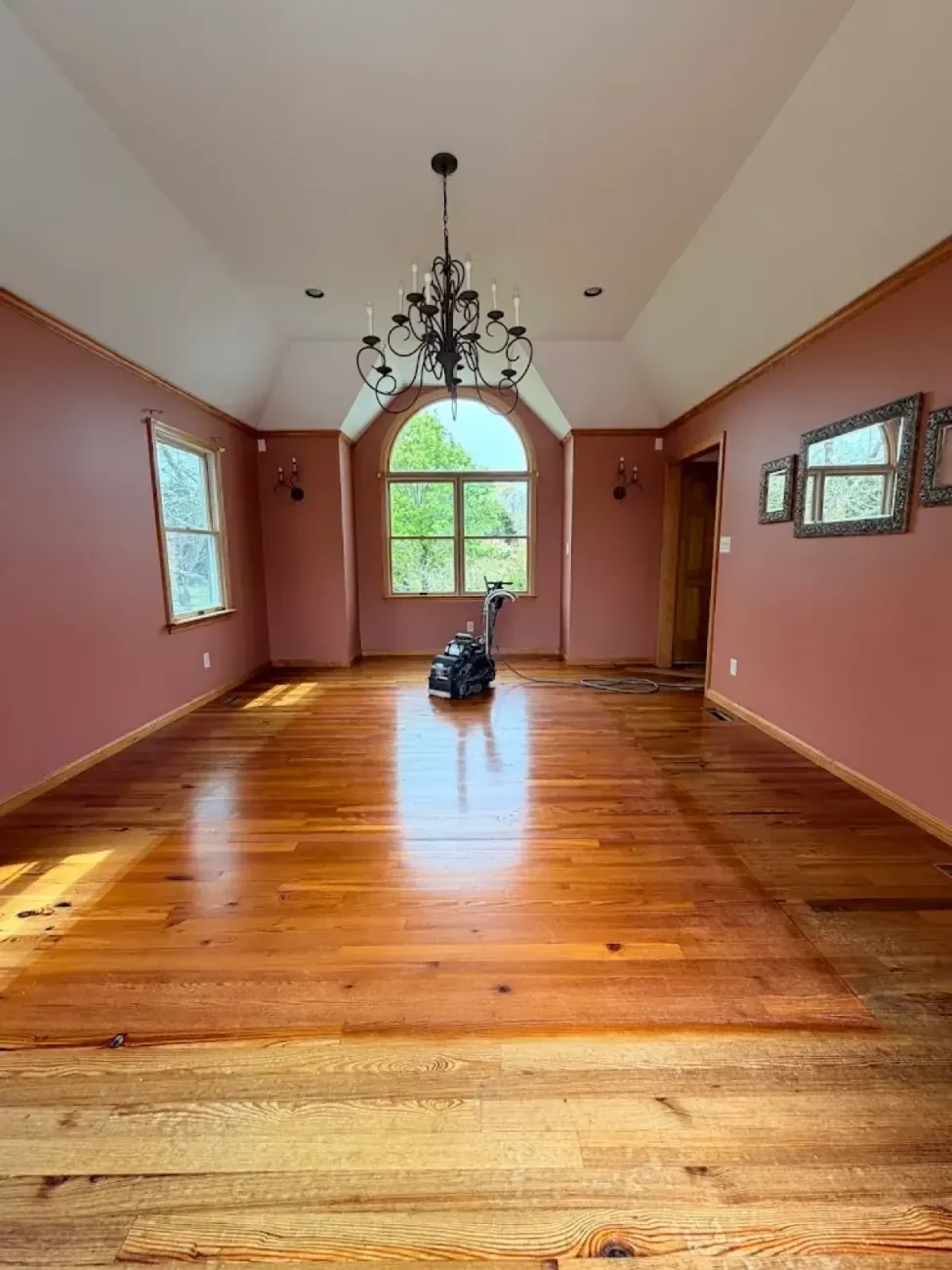 Orange-toned hardwood floor before professional refinishing