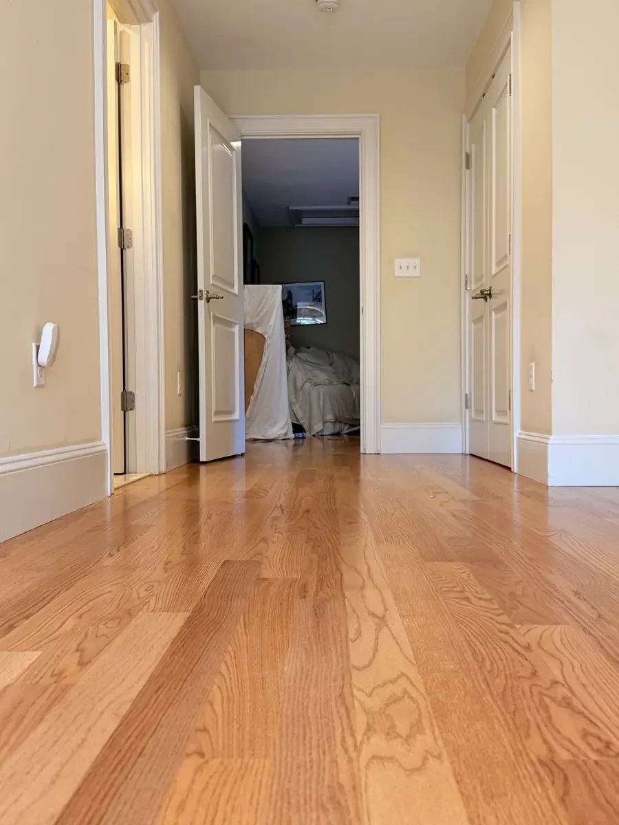 Completed red oak flooring in the Wellesley hallway and rear bedroom