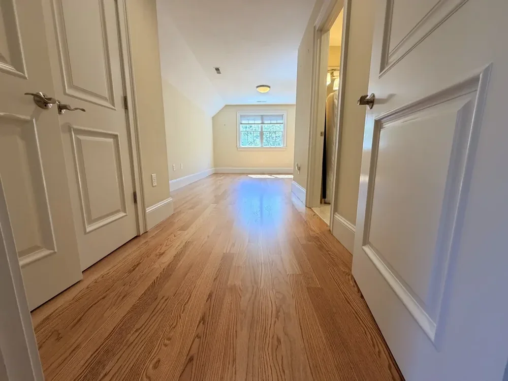 Completed red oak flooring in the Wellesley hallway and rear bedroom