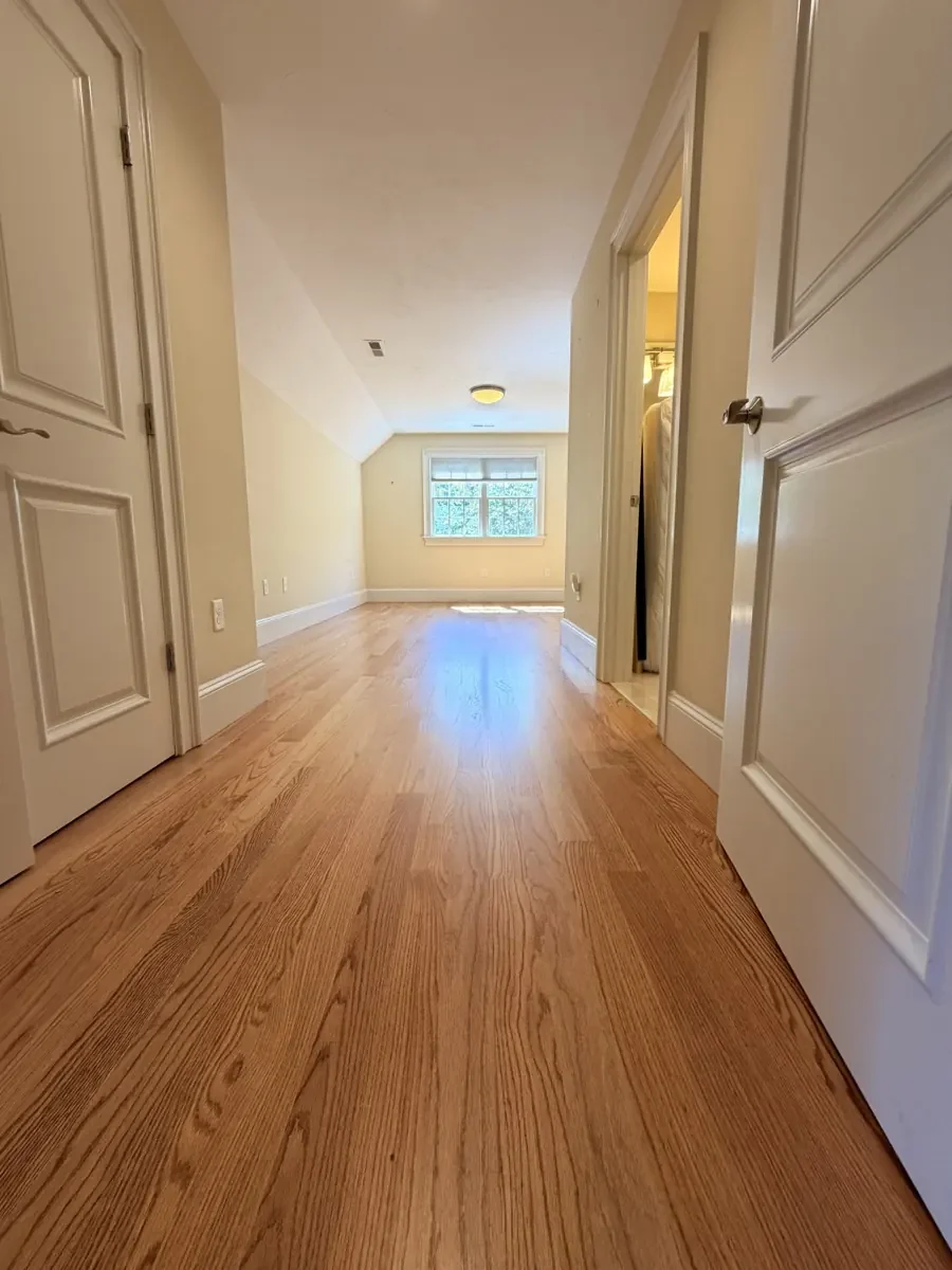 Completed red oak flooring in the Wellesley hallway and rear bedroom