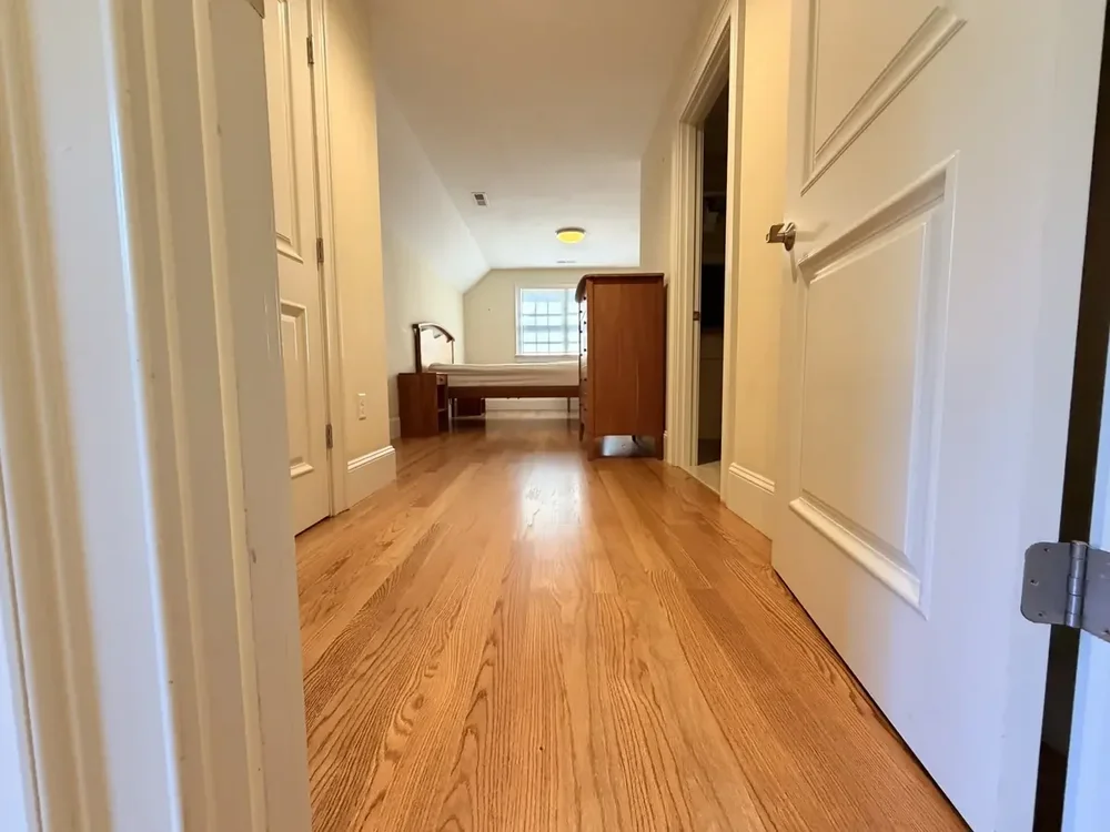Hallway with furniture returned after red oak installation and finishing