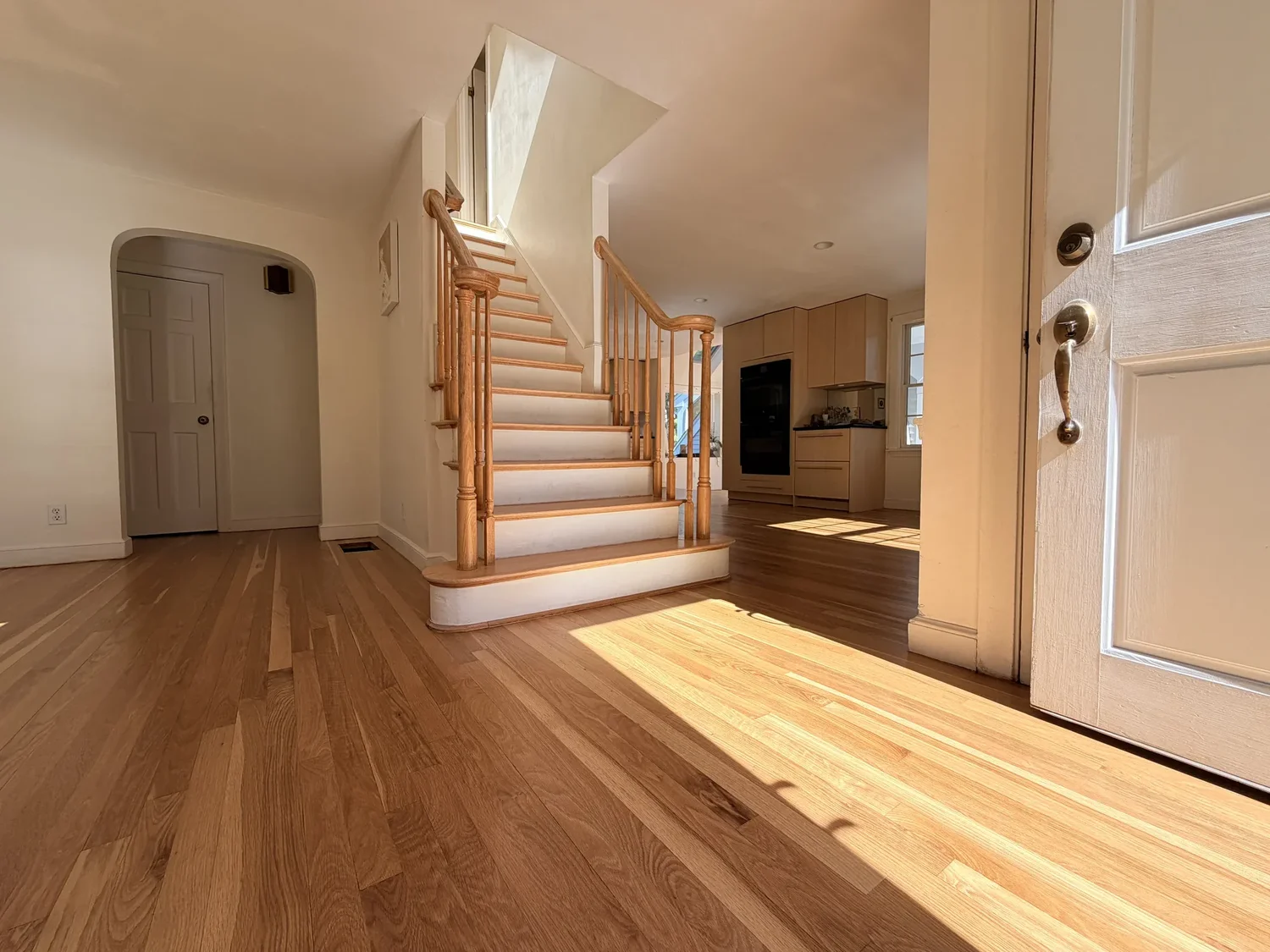 Naturally colored hardwood floors and staircase after refinishing in Concord, Massachusetts