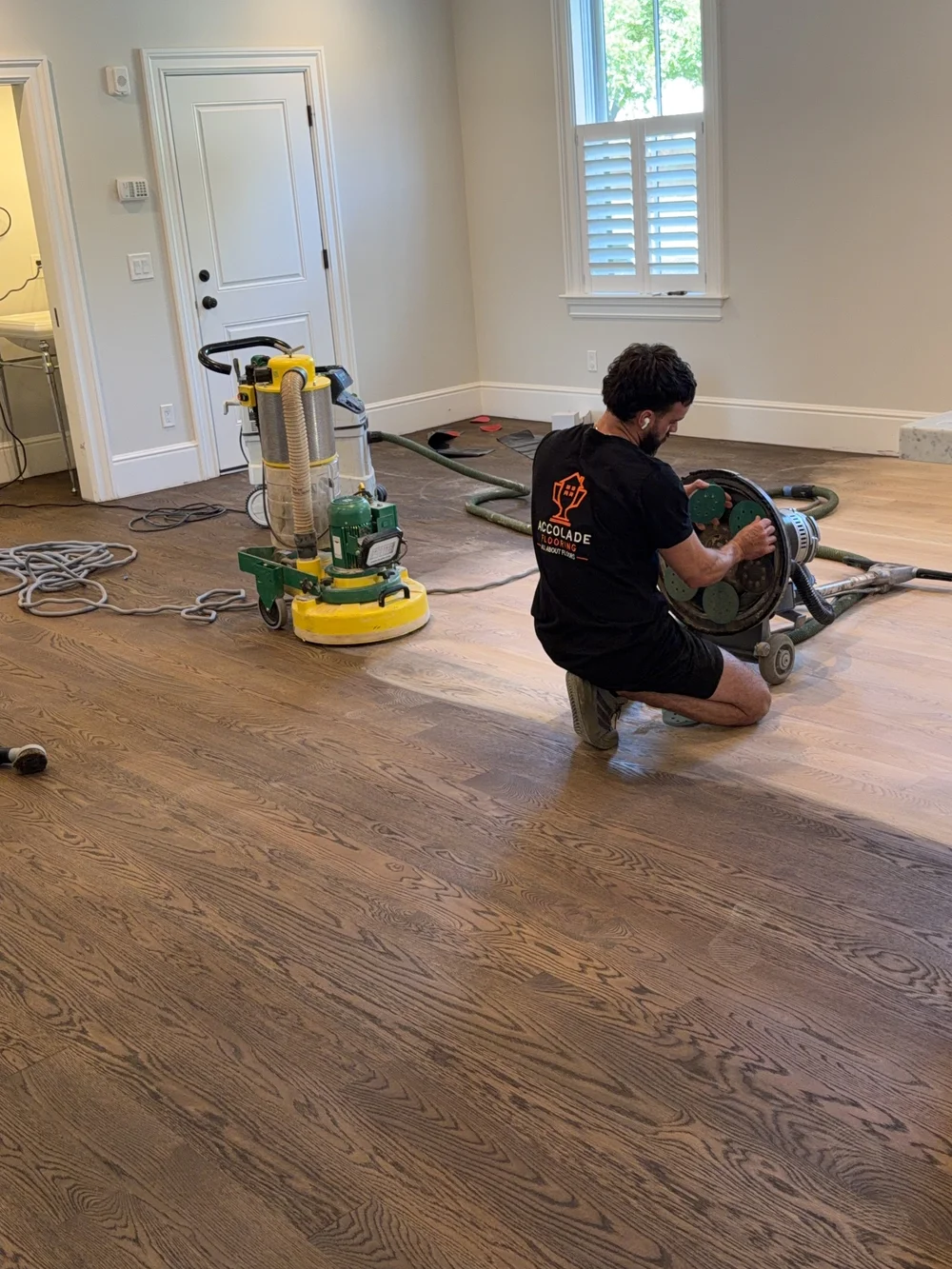 Professional hardwood floor sanding equipment in use