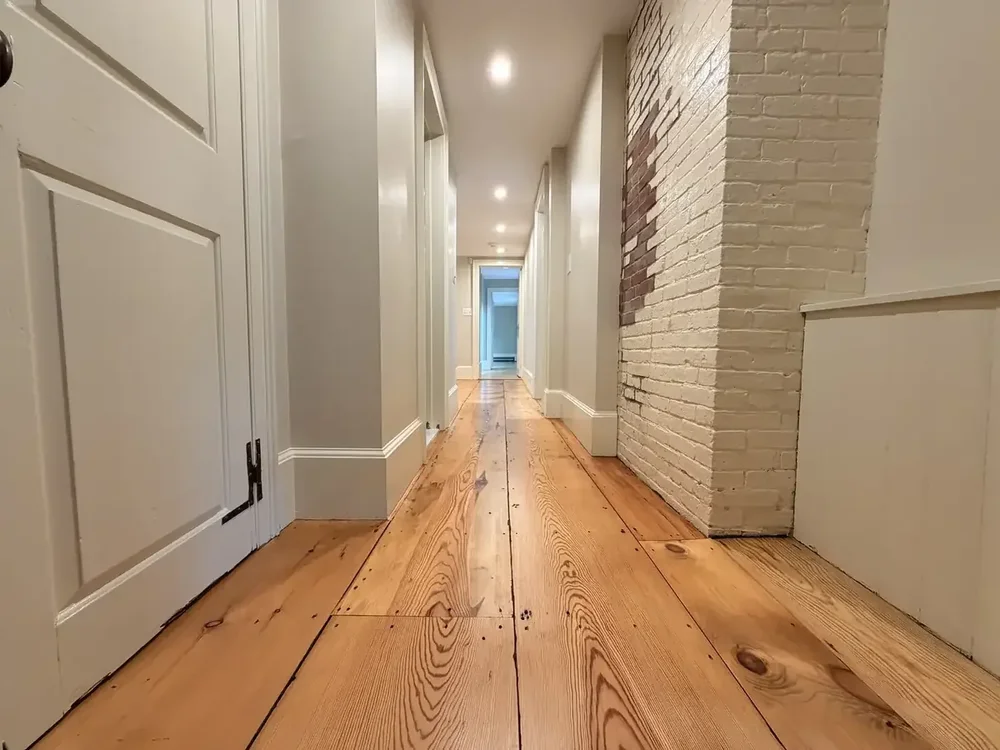 Restored historic wide-plank hallway in Weston
