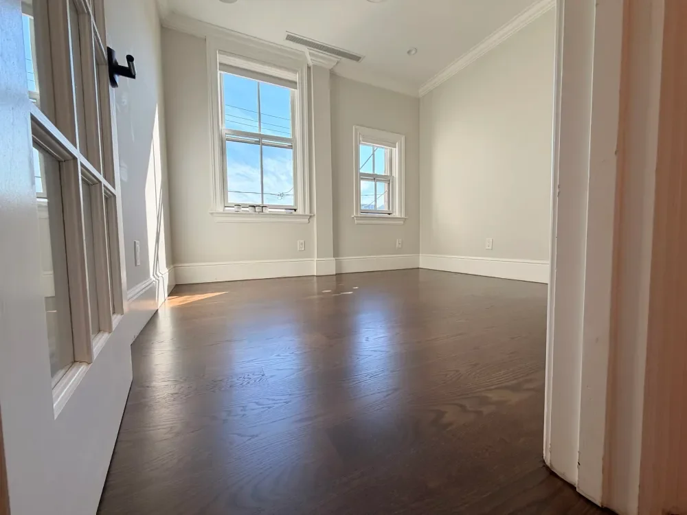 Completed dark hardwood floor refinishing by Accolade Flooring