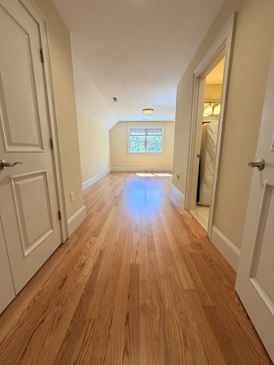 Completed red oak flooring in the Wellesley hallway and rear bedroom