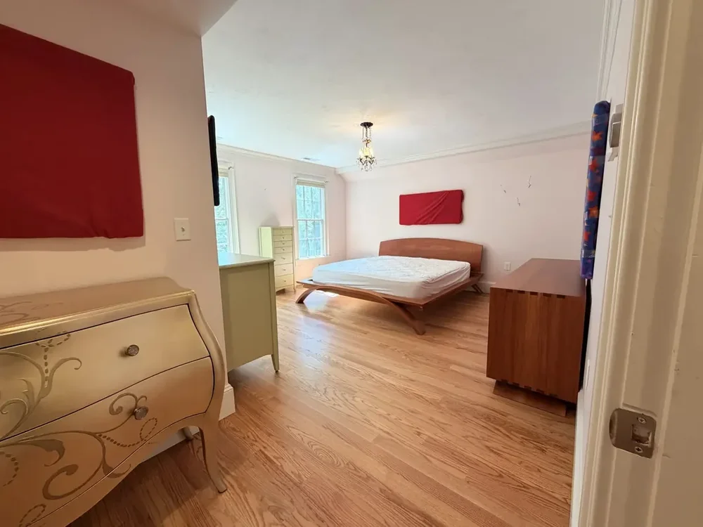 Furnished bedroom after red oak installation and finishing