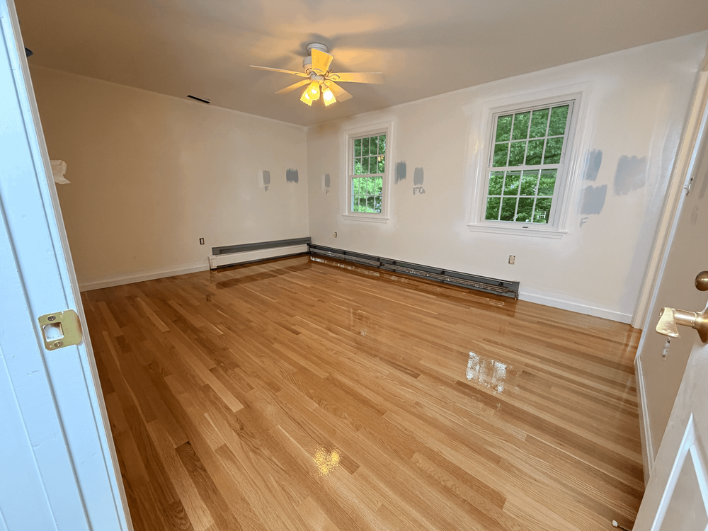 Finished white oak replacing carpet in the first Andover room
