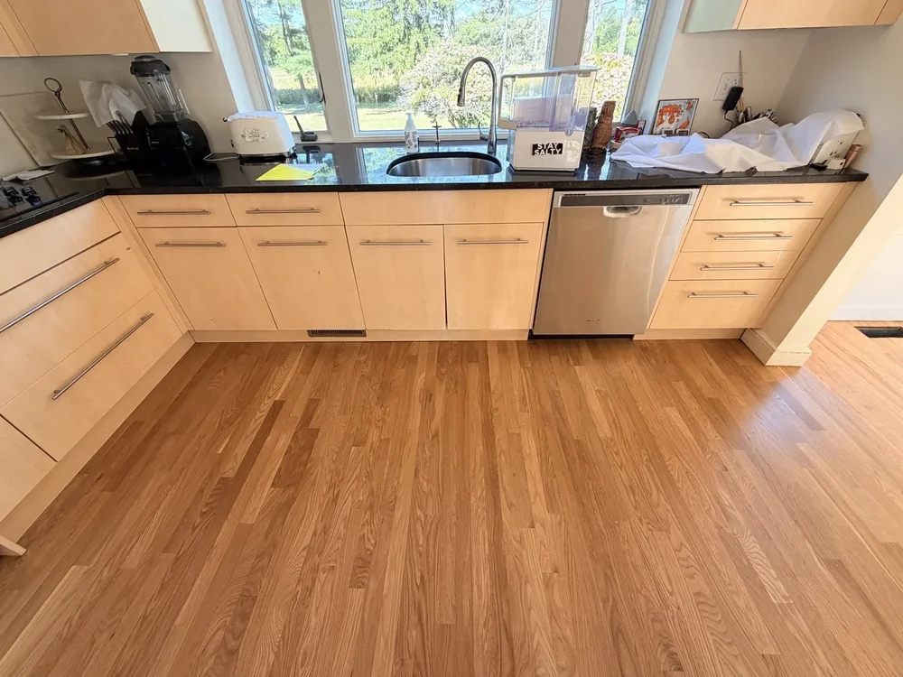 Completed satin-finished hardwood beneath the kitchen sink cabinetry