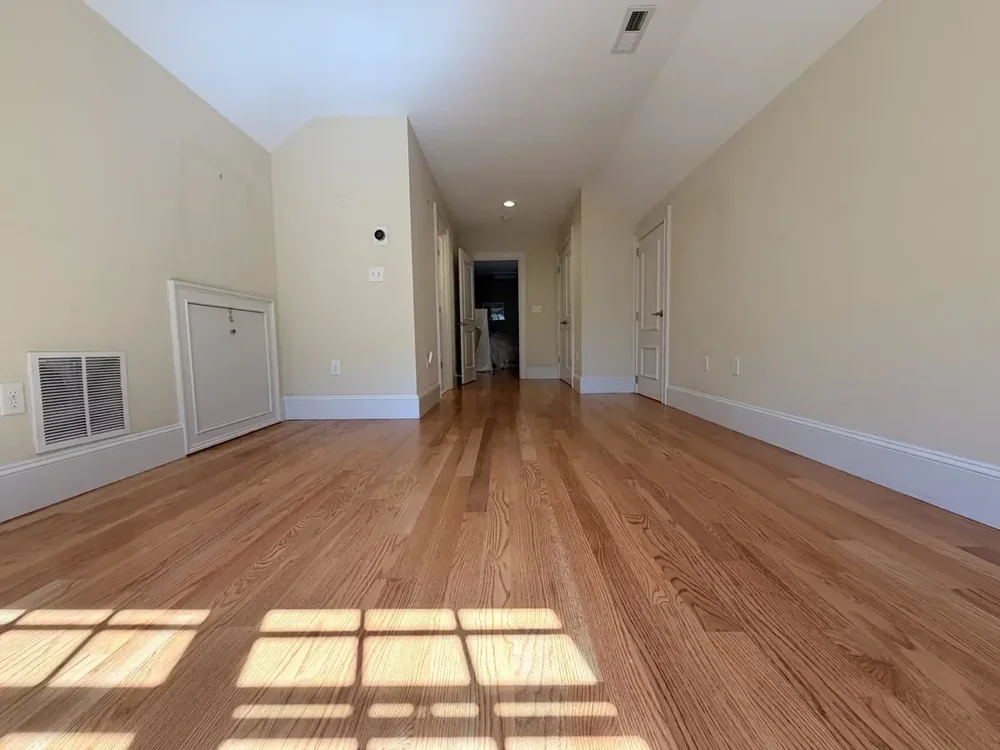Completed red oak flooring in the Wellesley hallway and rear bedroom