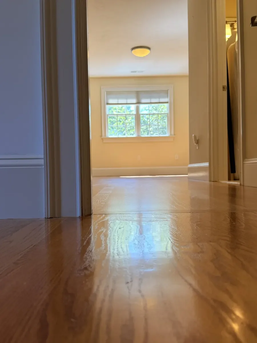 Completed red oak flooring in the Wellesley hallway and rear bedroom