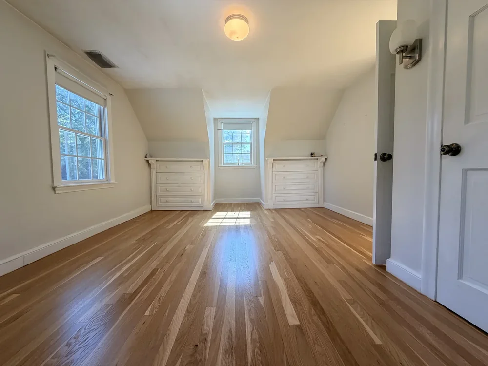 Upstairs room after hardwood floor sanding and refinishing in Concord