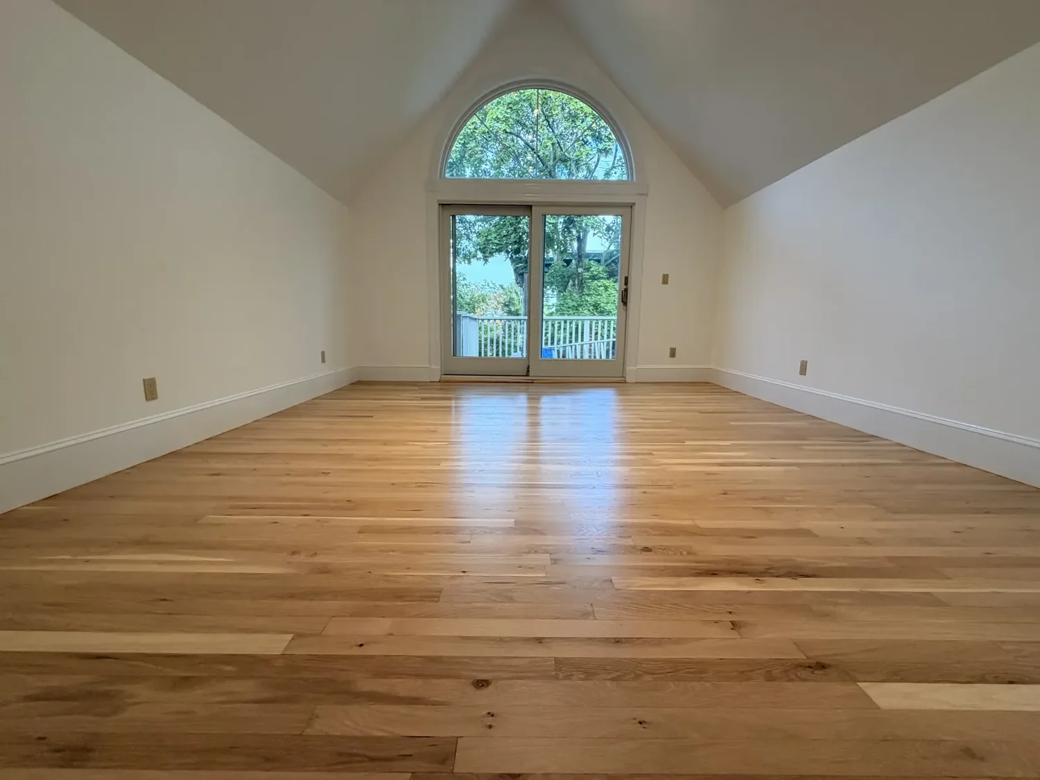 Completed hardwood refinishing in the main room of the Cambridge home