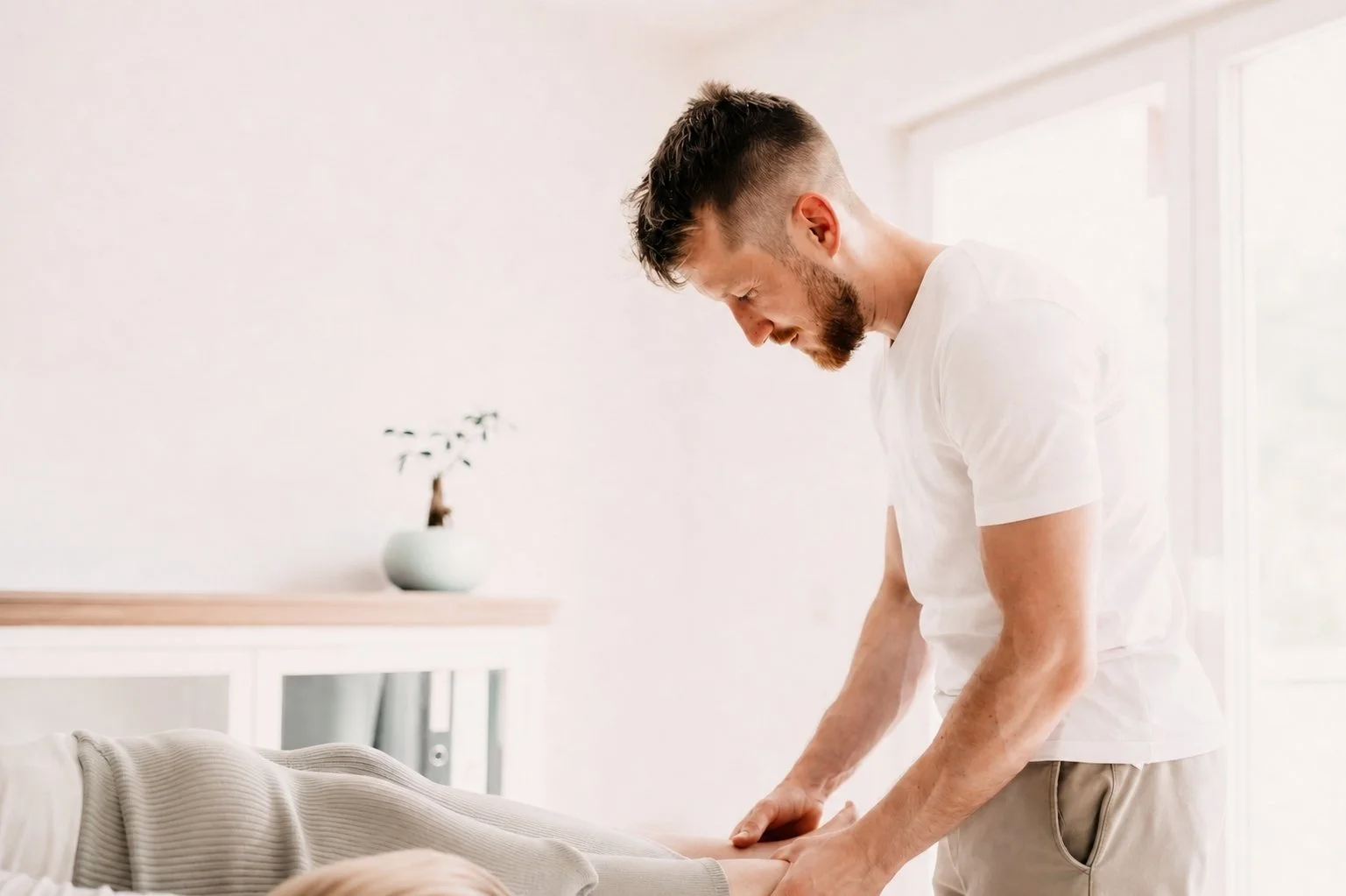 Johannes Thies während einer osteopathischen Behandlung in seiner Praxis in Darmstadt.