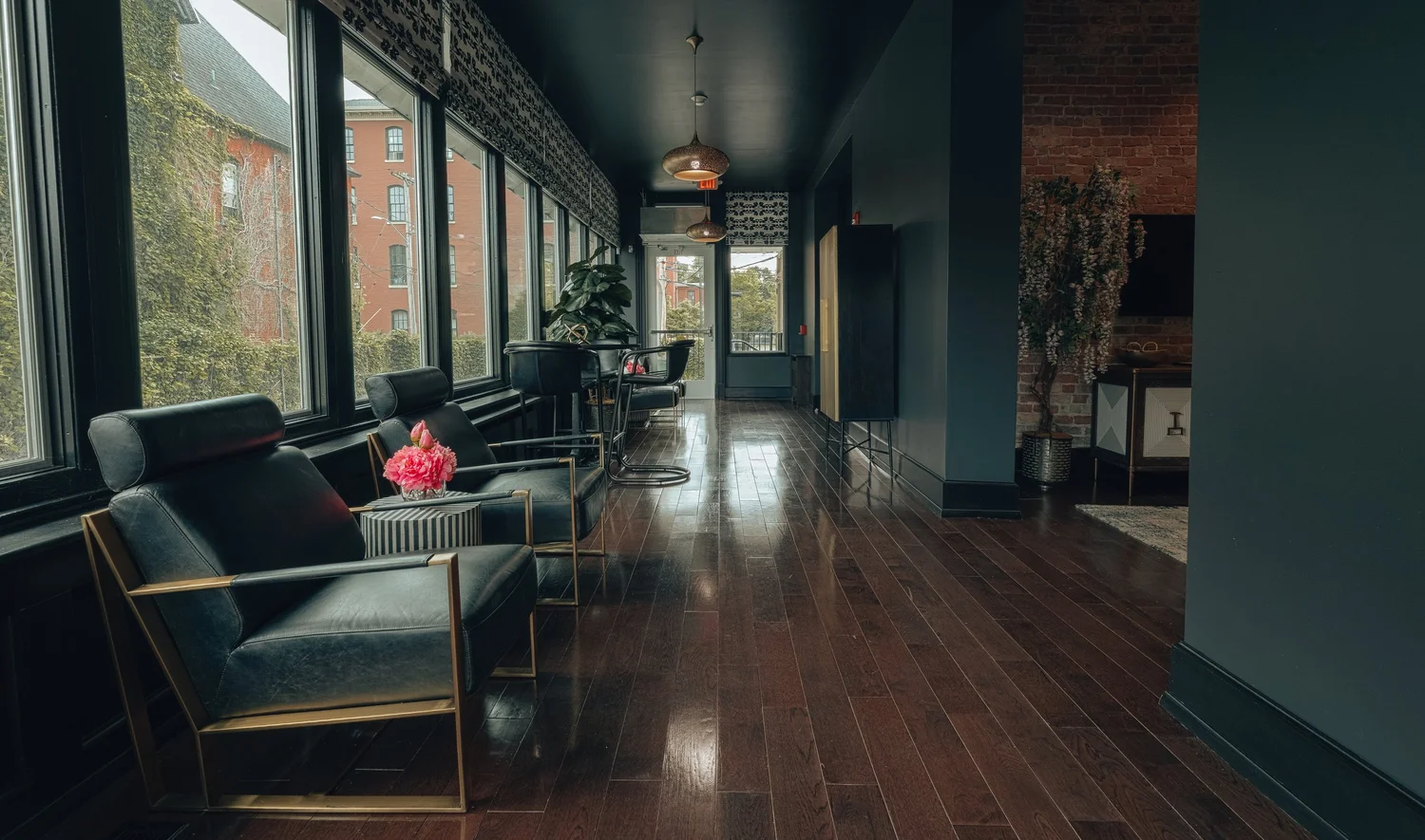 A sunlit sitting area along a row of windows