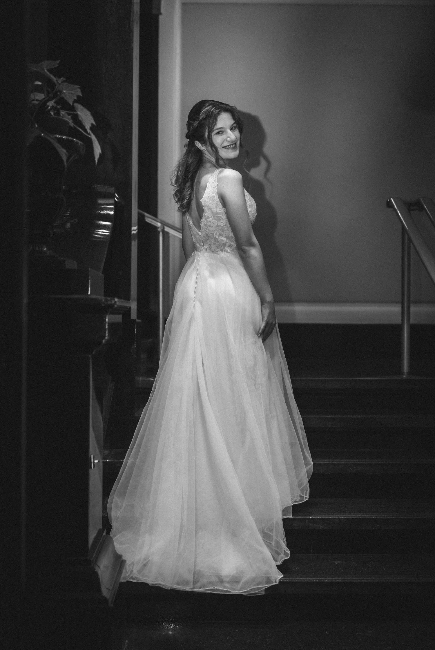 A bride in black and white looking over her shoulder