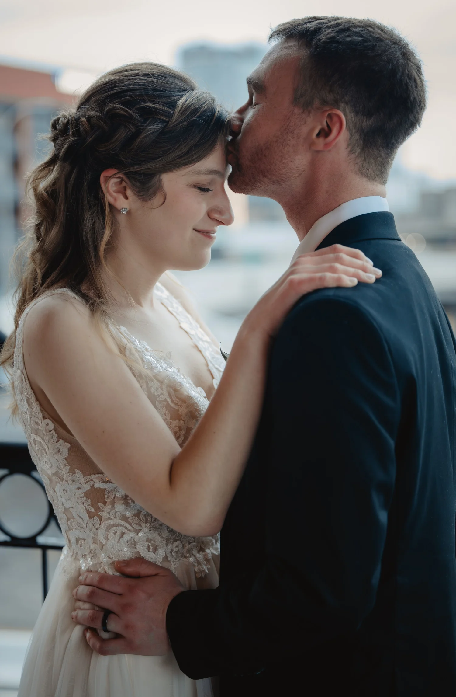 The groom kissing the bride on the cheek