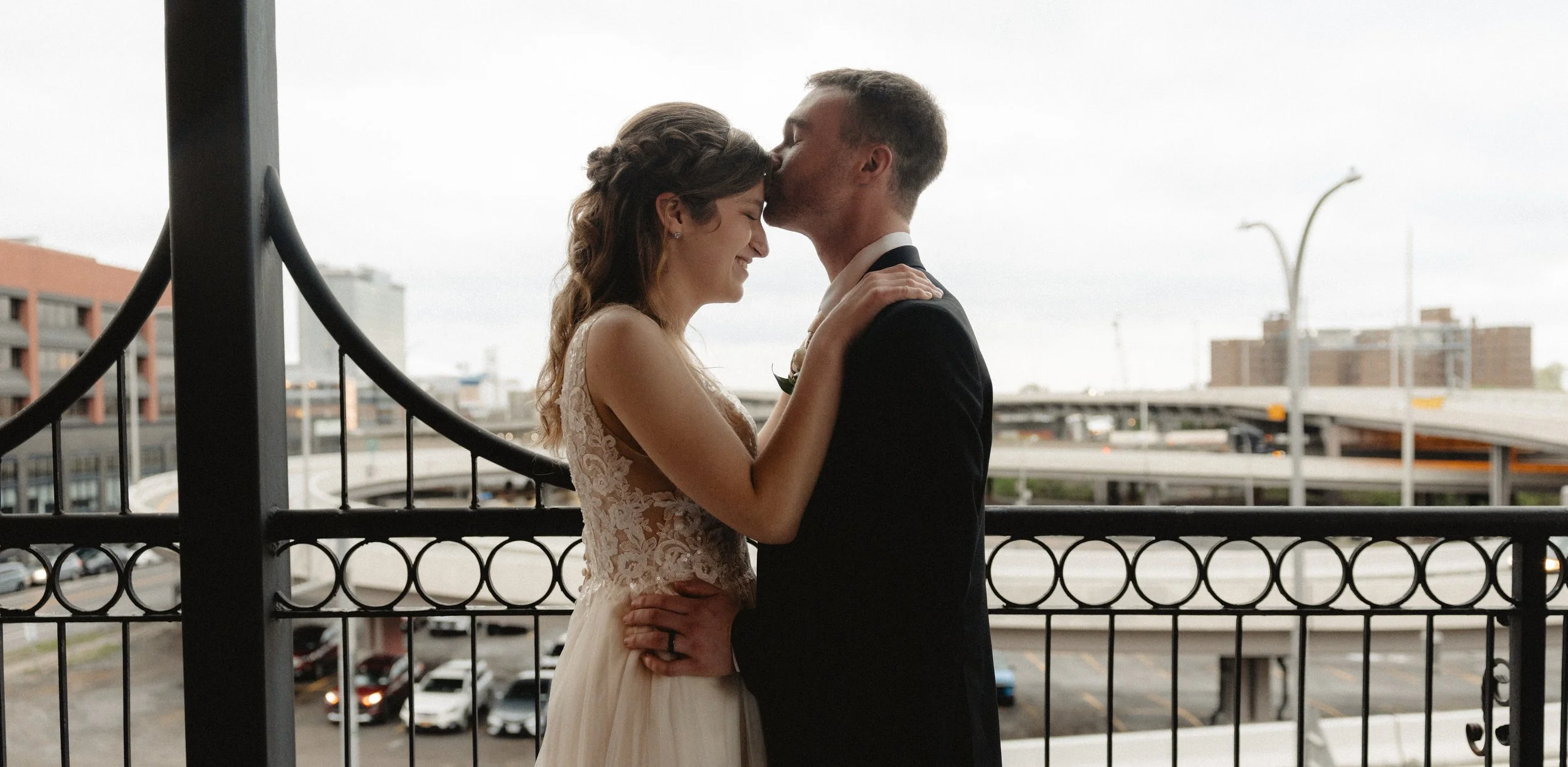 A couple sharing a quiet moment on a balcony above the city