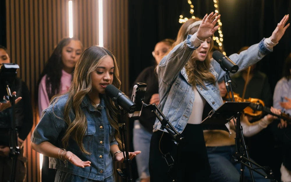 Singers leading worship on stage