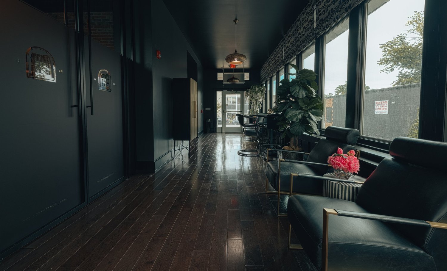A long hallway with a lounge chair