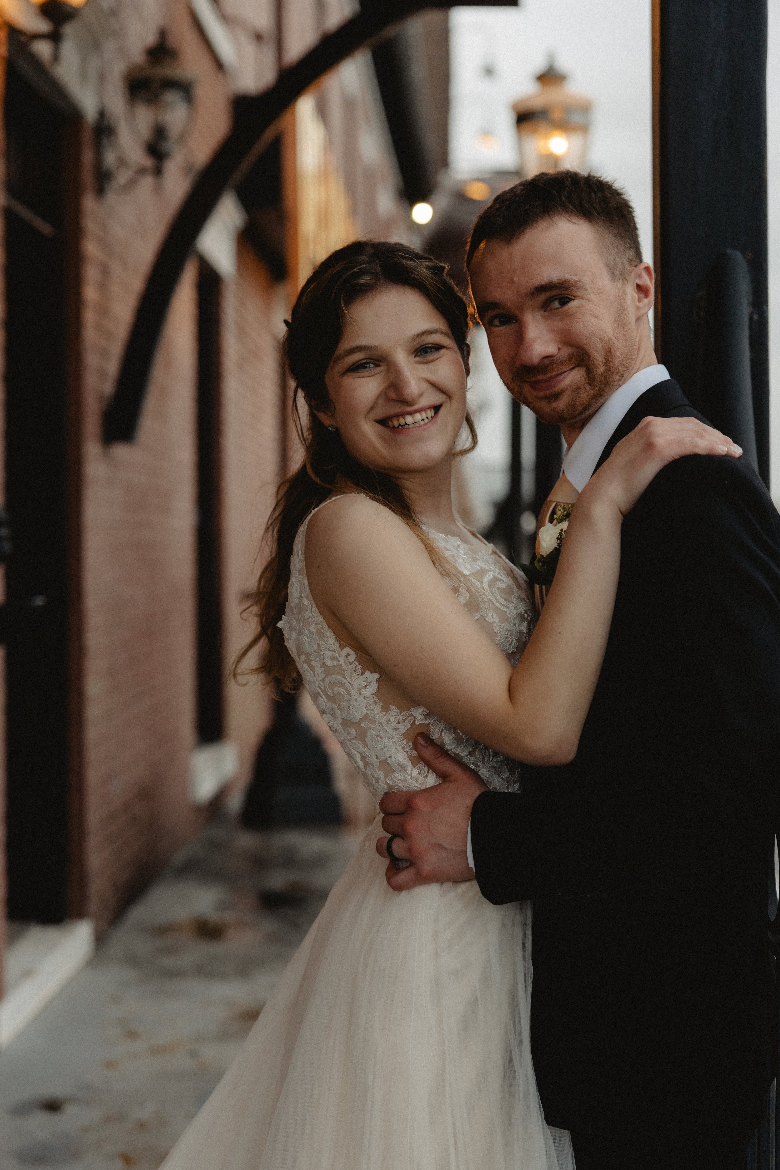 A bride and groom embracing and smiling